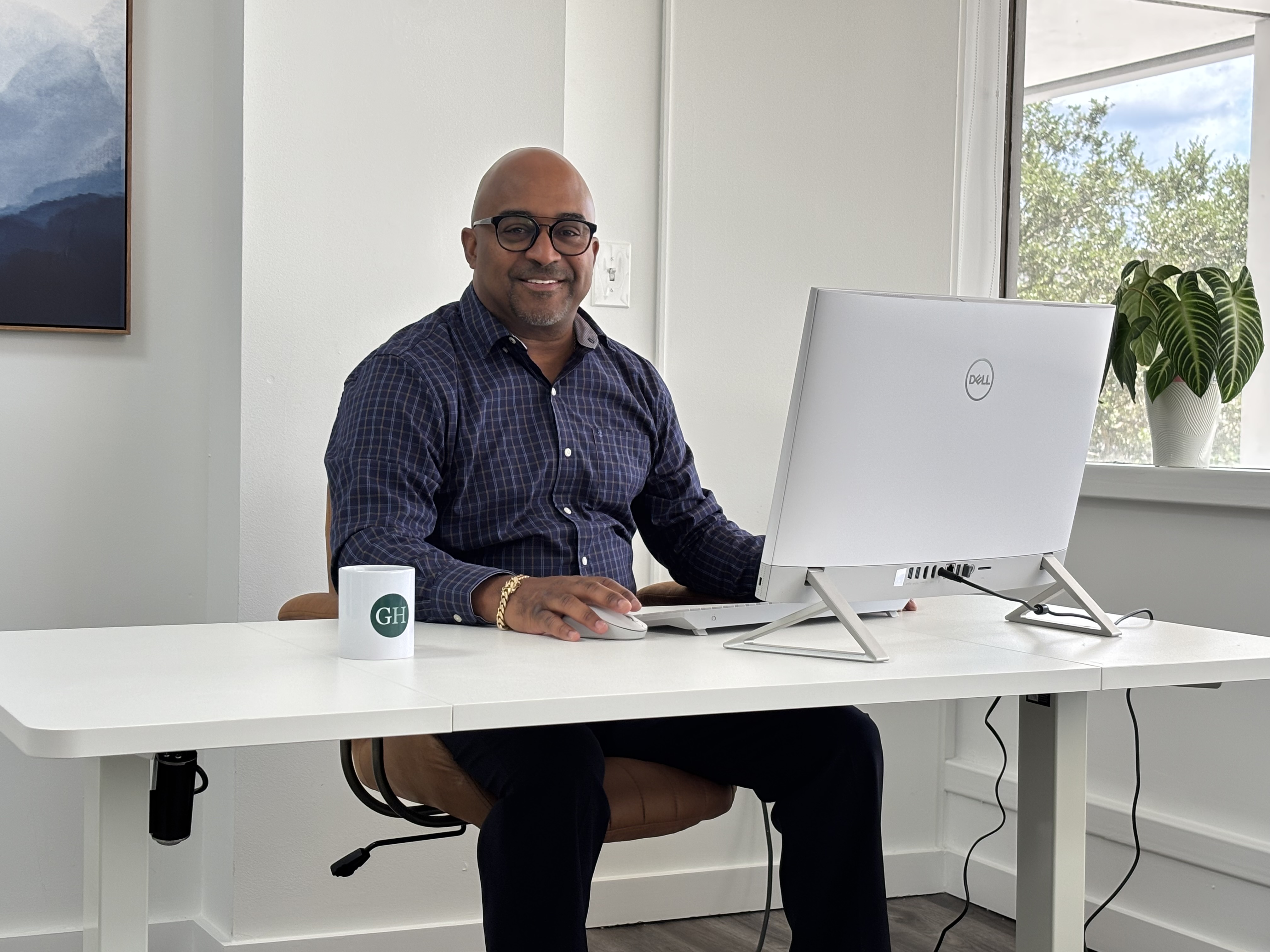 Mike Ransaw, Ed.S., LMHC, Clinical Director of Greet Health, at his desk